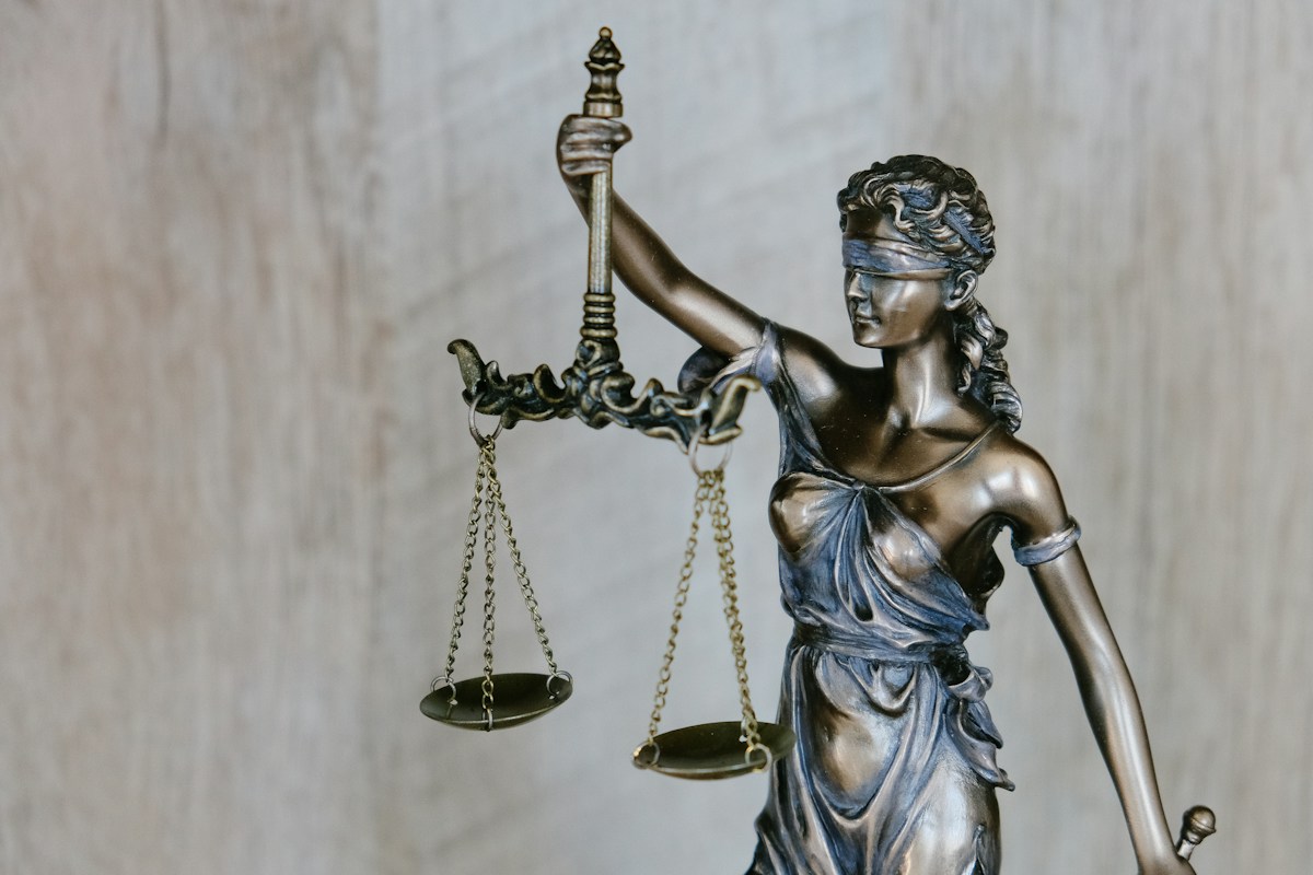 Statue of Lady Justice holding scales and a sword.